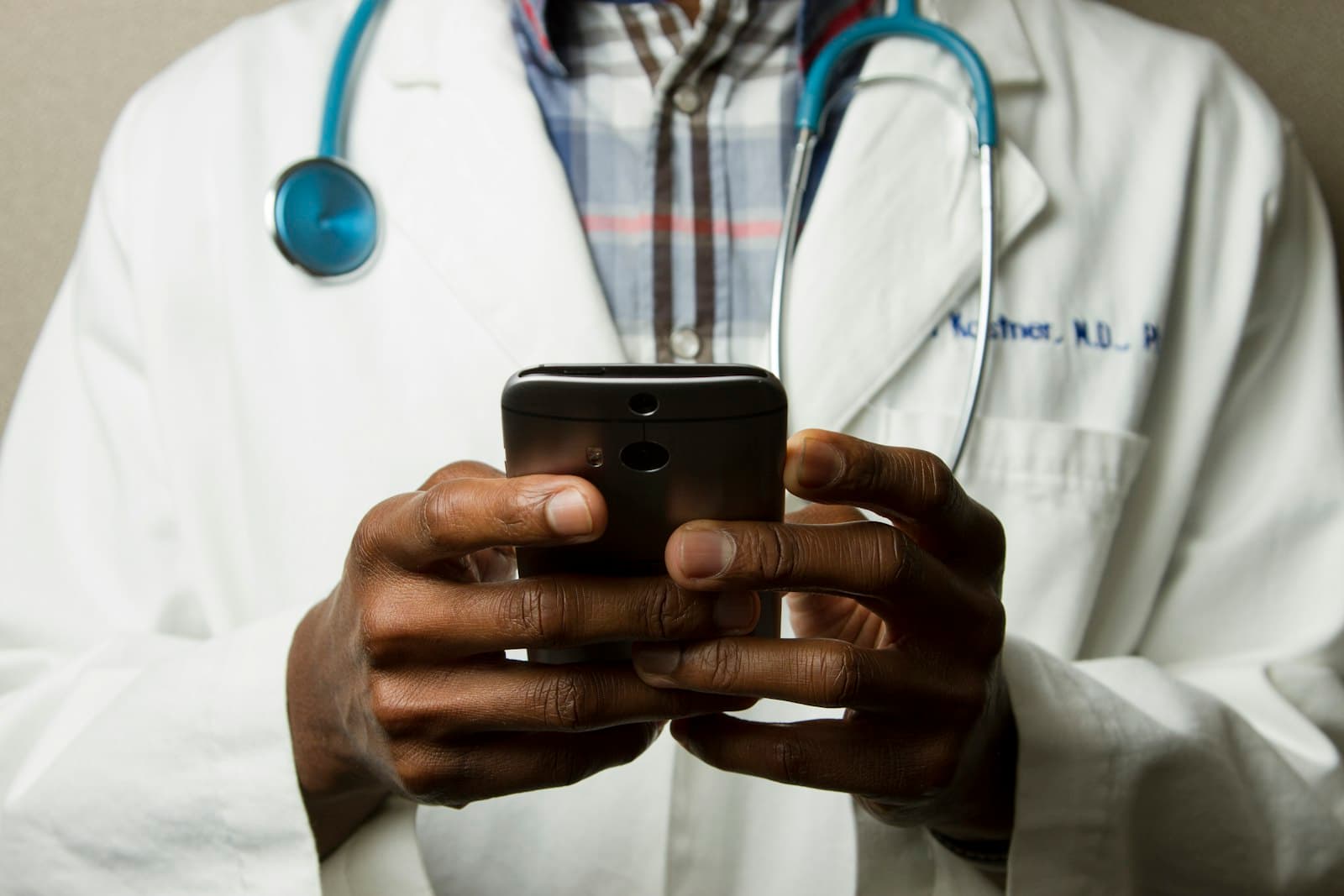 A doctor beside a car provided by the practice. The same statutory formula applies whether that car covers 10,000 kilometres a year or 40,000